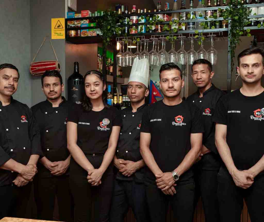 The complete team of Royal Spice Restaurant in Lisbon, including chefs and front staff.