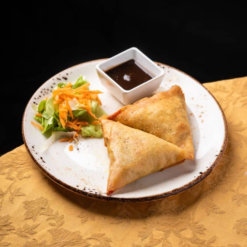 Crispy chicken samosas served as an started at our Indian restaurant for lunch or dinner in Lisbon.