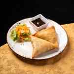Crispy chicken samosas served as an started at our Indian restaurant for lunch or dinner in Lisbon.