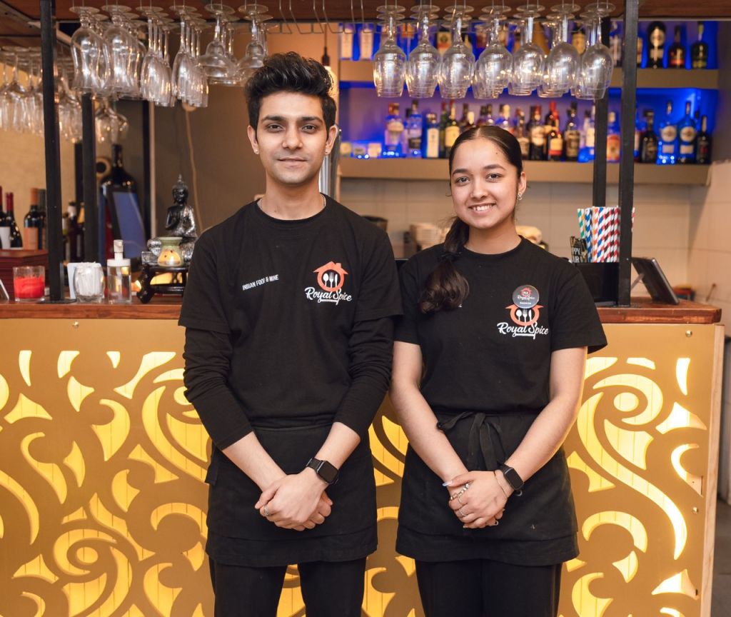 The front team of Royal Spice Restaurant in Lisbon, standing in front of the restaurant bar.
